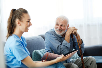 Nurse talking to smiling older man.