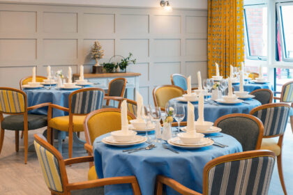 A dining room with beautifully laid tables