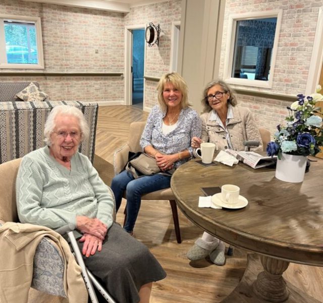 Residents socialising over drinks and refreshments at Beeston Rise Care Home